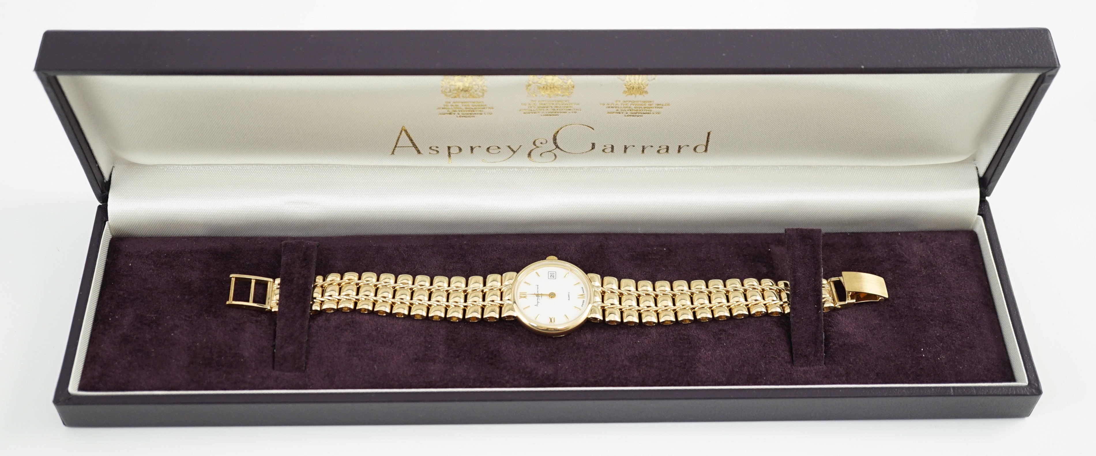 A lady's 2002 9ct gold Asprey & Garrard quartz wrist watch, on a 9ct gold bracelet